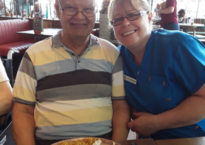 Abbotsleigh Care Home resident and staff member having lunch at Nandos