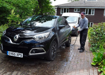 Resident cleaning a car at Abbotsleigh Care Home