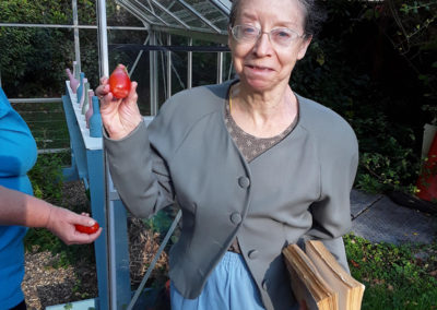 Abbotsleigh resident proudly showing off some home-grown tomatoes
