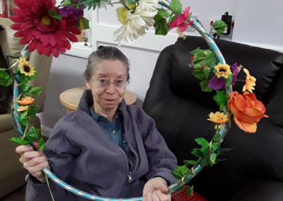 Abbotsleigh Care Home lady resident with a decorated hoop of flowers