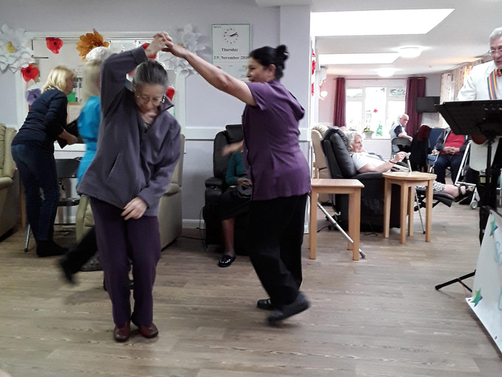 Abbotsleigh Care Home staff and residents dancing in the lounge together