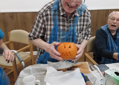 Abbotsleigh resident smiling with his pumpkin that he carved