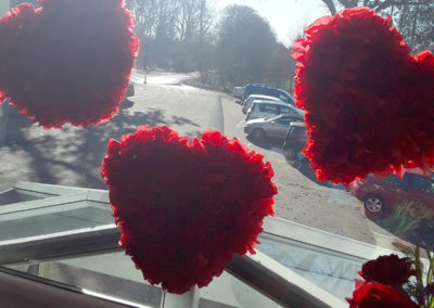 Valentines heart decorations on the window at Abbotsleigh Care Home