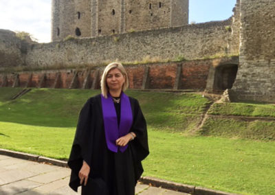 Abbotsleigh Care Home Manager in graduation gown in the grounds of Rochester Cathedral