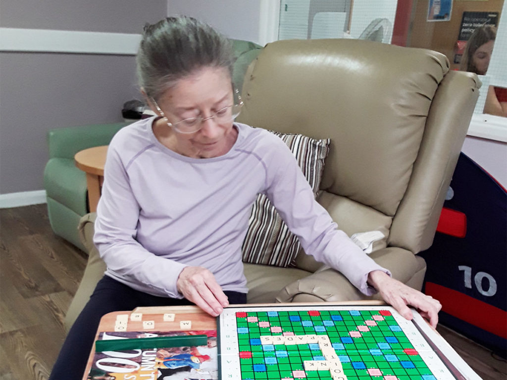 Lady resident at Abbotsleigh playing a game of Scrabble