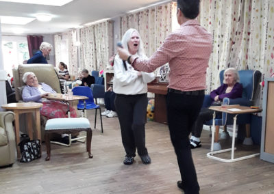 Lady resident dancing with singer Kevin Walsh at Abbotsleigh Care Home