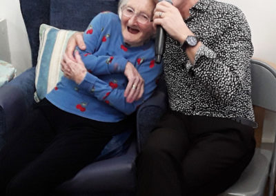 Singer Kevin Walsh cuddling a lady resident at Abbotsleigh Care Home