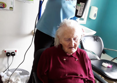 Lady resident getting her hair blow dried at Abbotsleigh Care Home