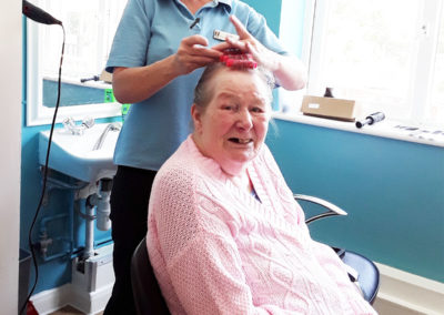 Lady resident having her hair done at Abbotsleigh Care Home