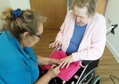 Lady resident having her nails done at Abbotsleigh Care Home