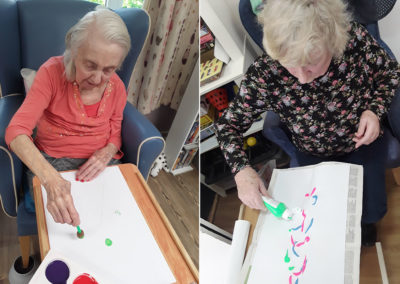 Two lady residents painting at Abbotsleigh Care Home