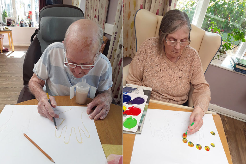 Two residents painting at Abbotsleigh Care Home