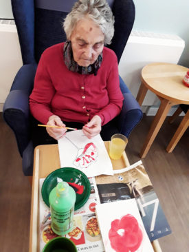 Lady resident painting at Abbotsleigh Care Home