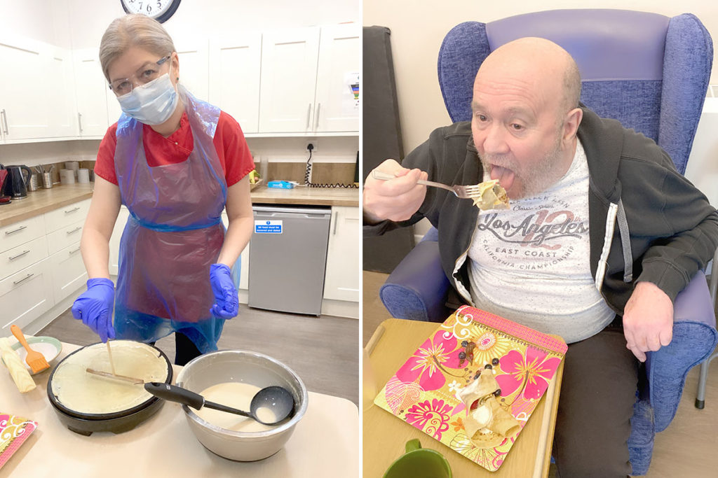 Manager making pancakes and resident eating one at Abbotsleigh Care Home