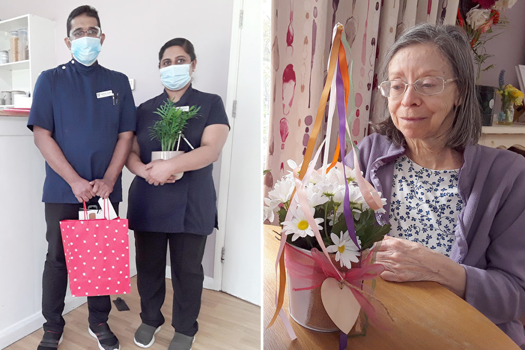 Two staff members with their leaving presents and a resident creating a May Day maypole flower arrangement at Abbotsleigh Care Home