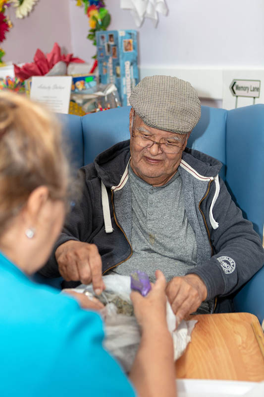One of the gentlemen at Abbotsleigh Care Home making lavender bags with Esme our Recreation and Well-Being Champion