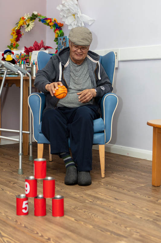 One of the gentlemen at Abbotsleigh Care Home playing Tin Can Alley