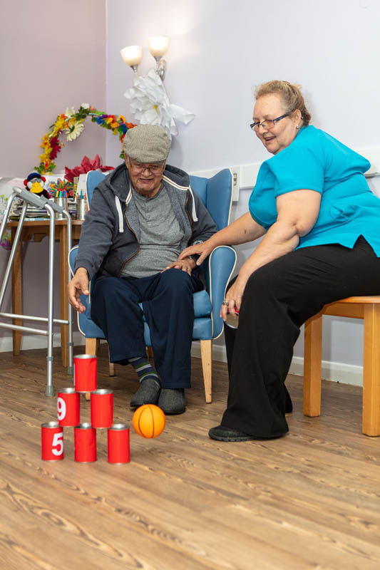 One of the gentlemen at Abbotsleigh Care Home playing Tin Can Alley