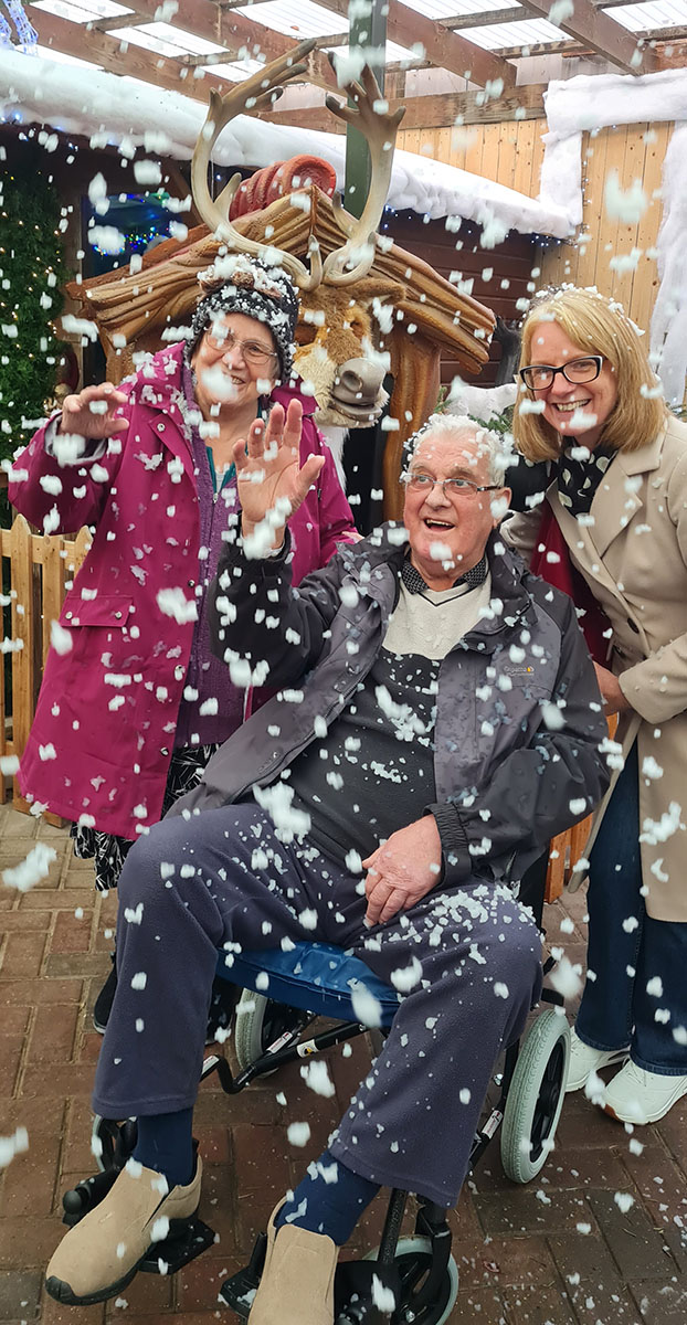 Abbotsleigh Care Home resident and family enjoying a snow scene at Millbrook Garden Centre